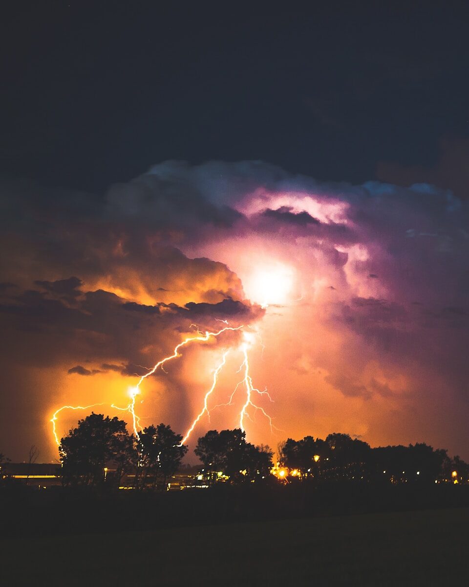 Lightning illuminating storm clouds at night