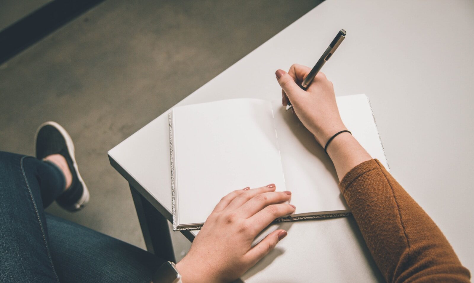 Person writing an essay by hand