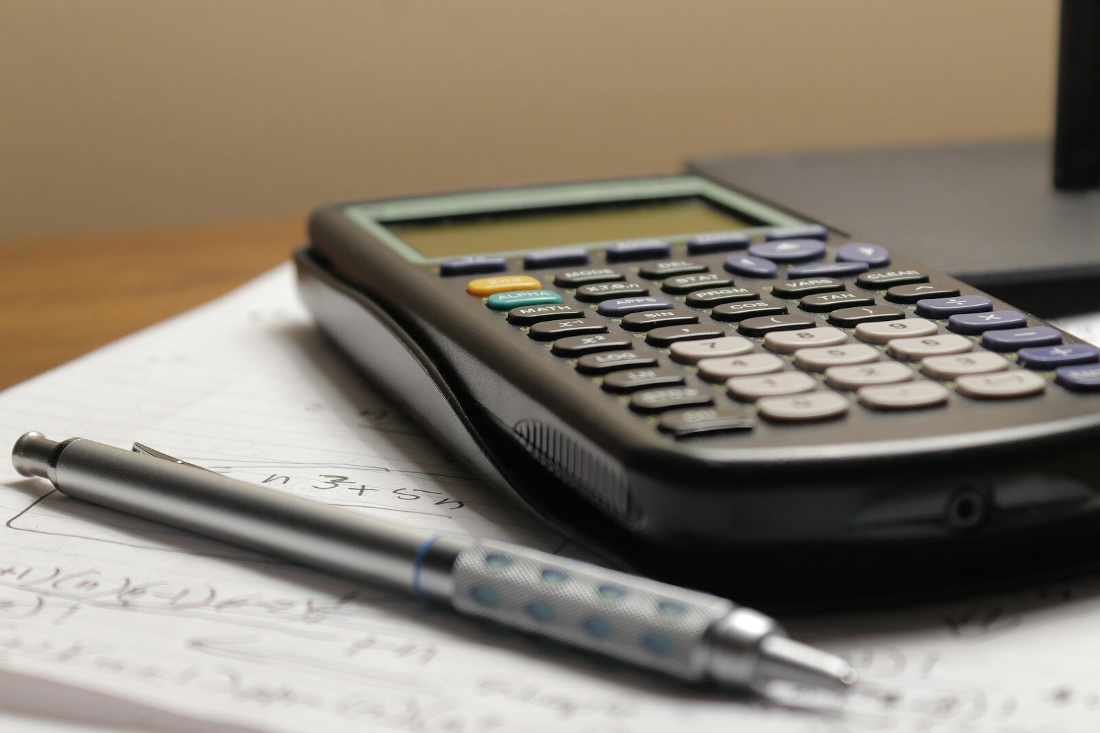 Calculator and pen resting on paperwork