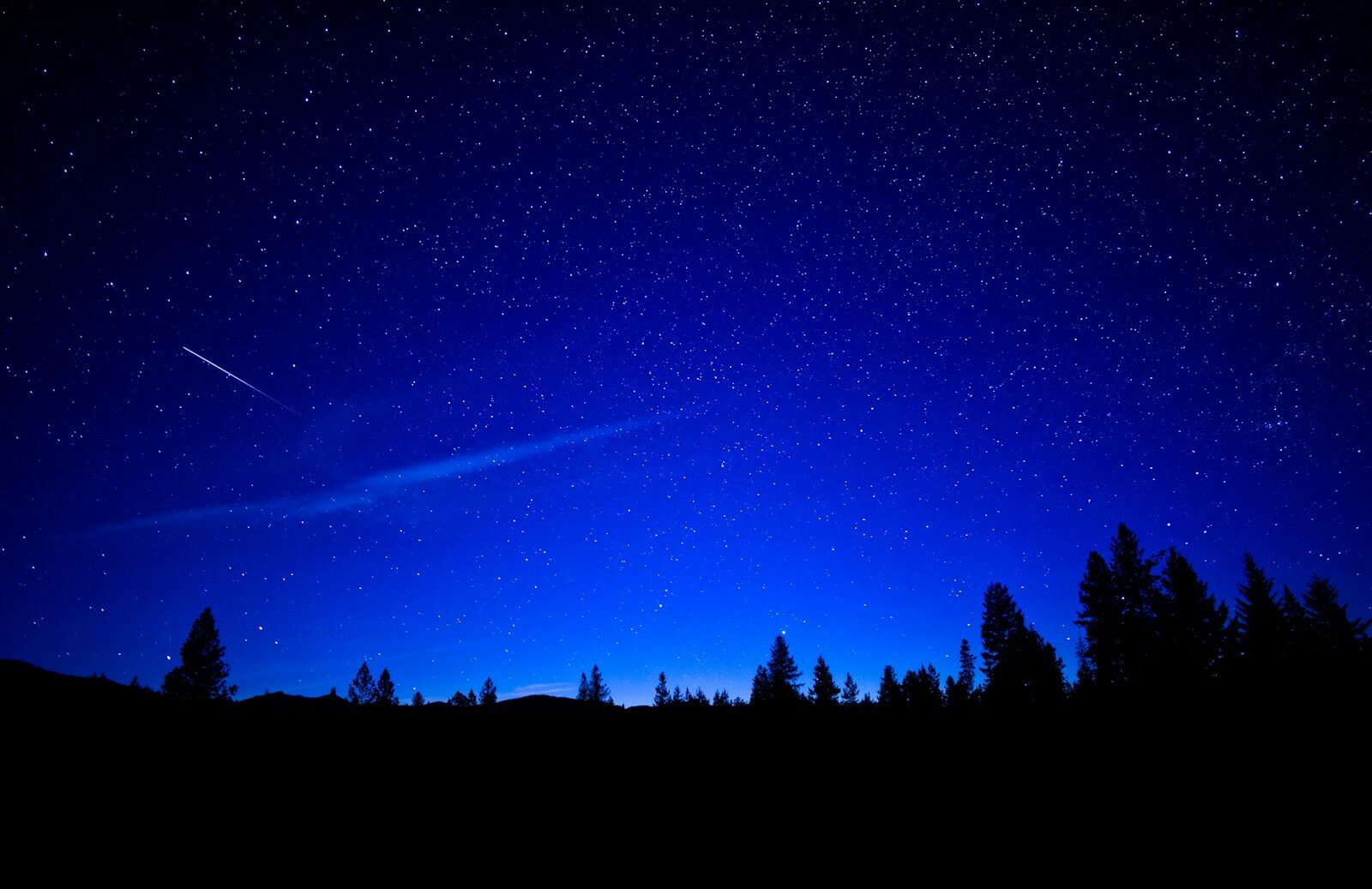 Bright meteor streaking across a dark star-filled sky