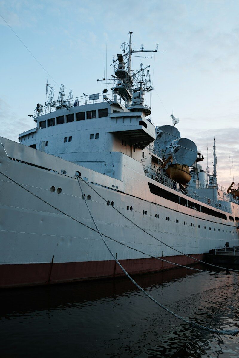 Large white research vessel docked in a harbour